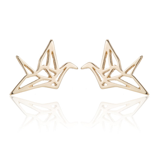 A pair of gold-toned geometric stud earrings shaped like stylized cranes, displayed on a clean white background with a soft reflection below.