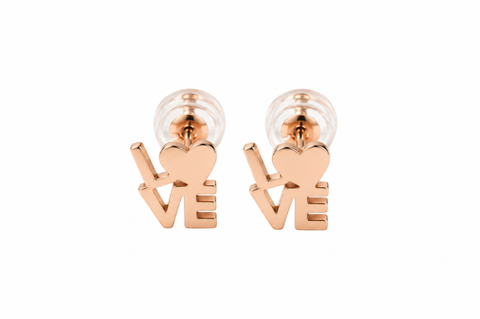 A pair of rose gold stud earrings shaped like the word 'LOVE', with the 'O' represented by a heart, shown on a plain white background.