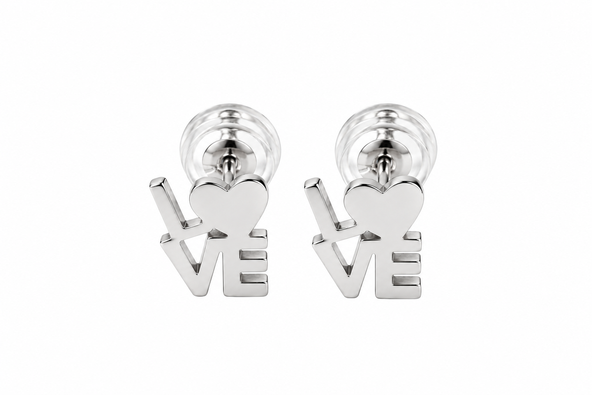 A pair of silver stud earrings shaped like the word LOVE, with a heart symbol replacing the O, shown on a plain white background.
