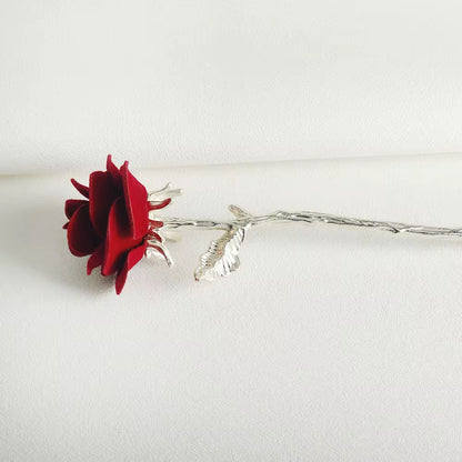 Scarlet Love red velvet rose hair stick featuring a sculpted silver-tone stem and decorative leaf detailing.