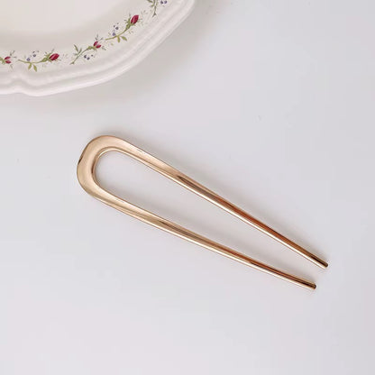 Simply Golden Barely There gold-tone hair fork featuring a sleek, rounded silhouette and minimalist double-prong design.