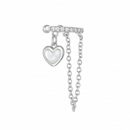 Silver-tone Heartstrings ear cuff with clear rhinestone accents, a pale iridescent heart-shaped charm, and draped chains on a white background.